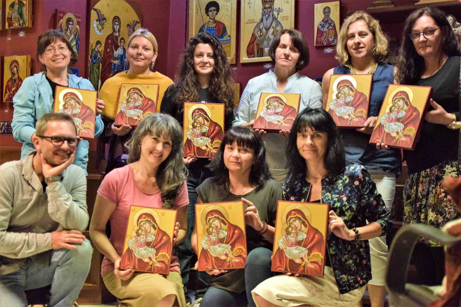 Alexandra Kaouki with her students holding completed Byzantine icons during an iconography workshop