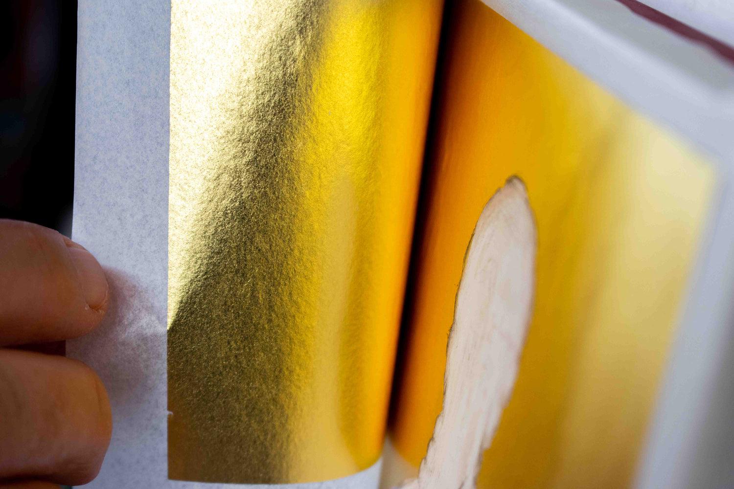 Gold leaf application on Byzantine icon panel as part of traditional iconography technique